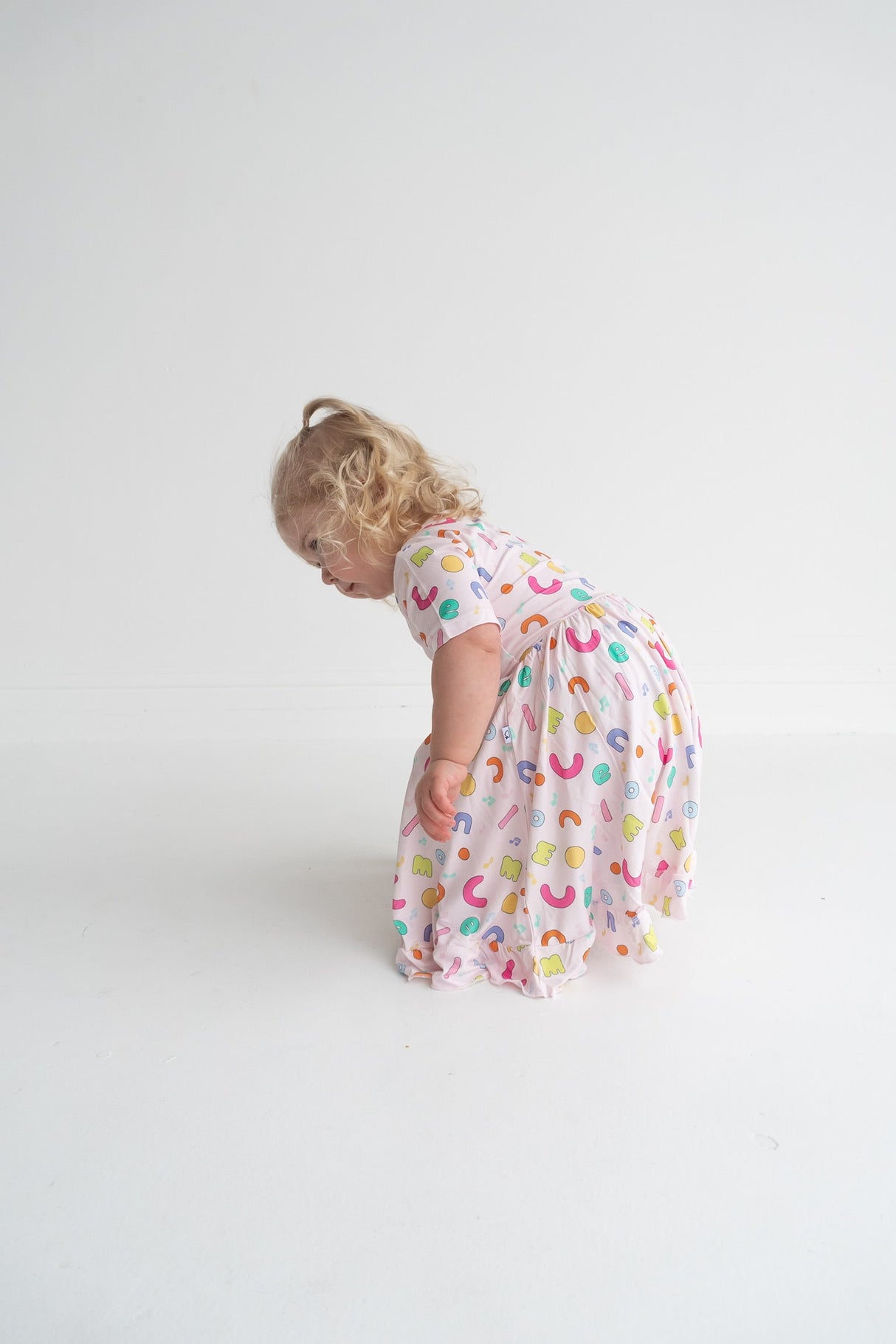 Dream Big Little Co x CoComelon ALPHABET SHORT SLEEVE DREAM RUFFLE DRESS from DREAM BIG LITTLE CO
