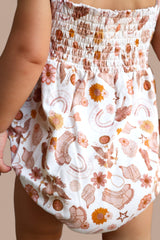 FLOWERS AND BOOTS DREAM BUBBLE ROMPER from DREAM BIG LITTLE CO