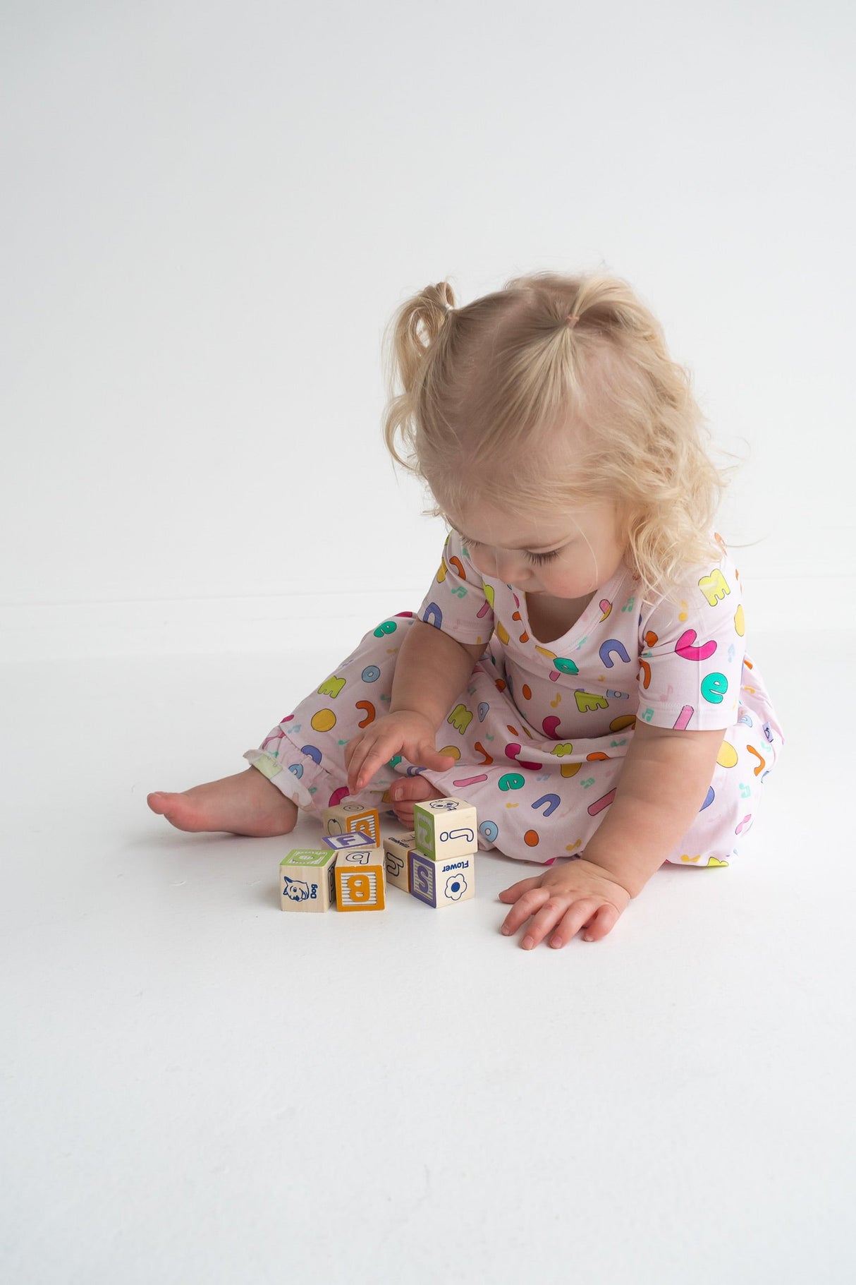 Dream Big Little Co x CoComelon ALPHABET SHORT SLEEVE DREAM RUFFLE DRESS from DREAM BIG LITTLE CO