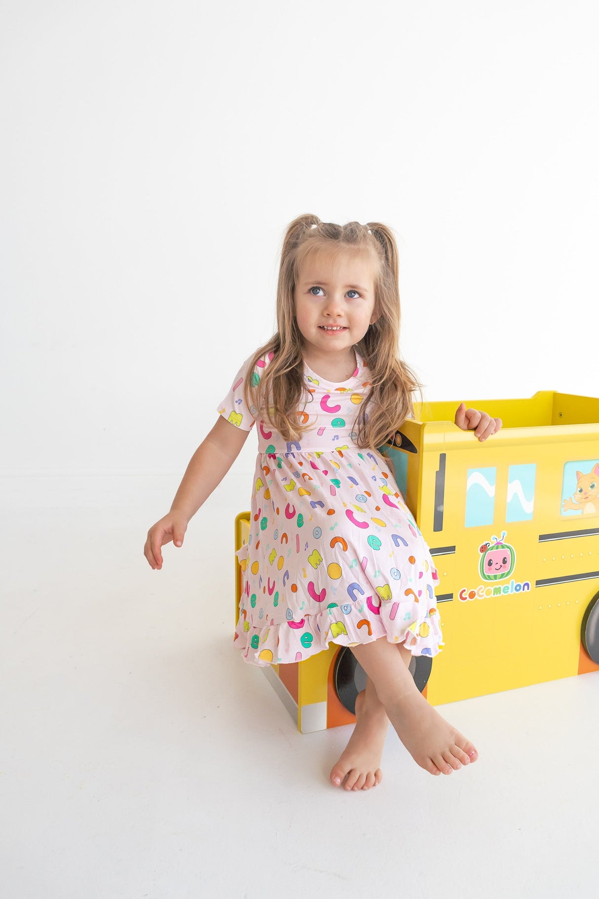 Dream Big Little Co x CoComelon ALPHABET SHORT SLEEVE DREAM RUFFLE DRESS from DREAM BIG LITTLE CO