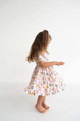 Dream Big Little Co x CoComelon JJ RAINBOW CHECKERS SHORT SLEEVE DREAM RUFFLE DRESS from DREAM BIG LITTLE CO