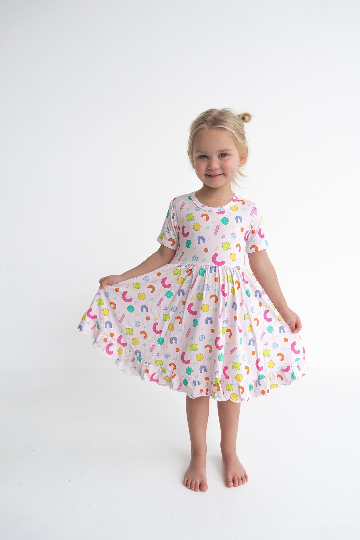 Dream Big Little Co x CoComelon ALPHABET SHORT SLEEVE DREAM RUFFLE DRESS from DREAM BIG LITTLE CO