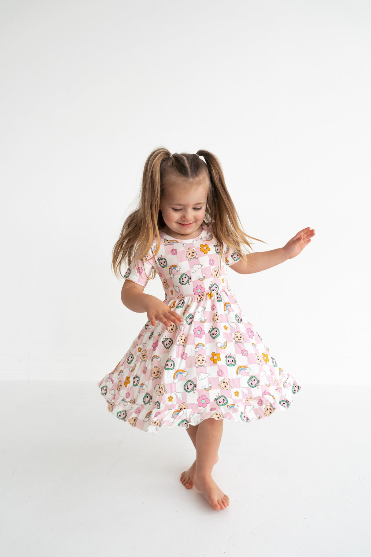Dream Big Little Co x CoComelon JJ RAINBOW CHECKERS SHORT SLEEVE DREAM RUFFLE DRESS from DREAM BIG LITTLE CO