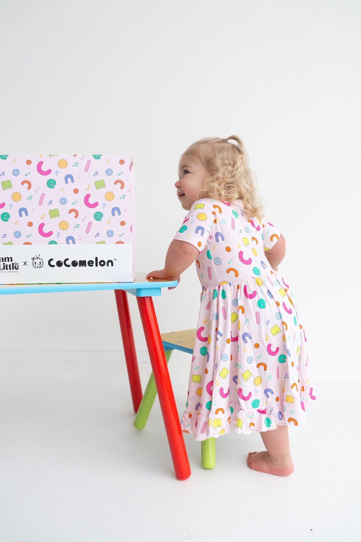 Dream Big Little Co x CoComelon ALPHABET SHORT SLEEVE DREAM RUFFLE DRESS from DREAM BIG LITTLE CO