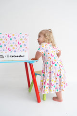 Dream Big Little Co x CoComelon ALPHABET SHORT SLEEVE DREAM RUFFLE DRESS from DREAM BIG LITTLE CO