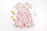 Dream Big Little Co x CoComelon ALPHABET SHORT SLEEVE DREAM RUFFLE DRESS from DREAM BIG LITTLE CO