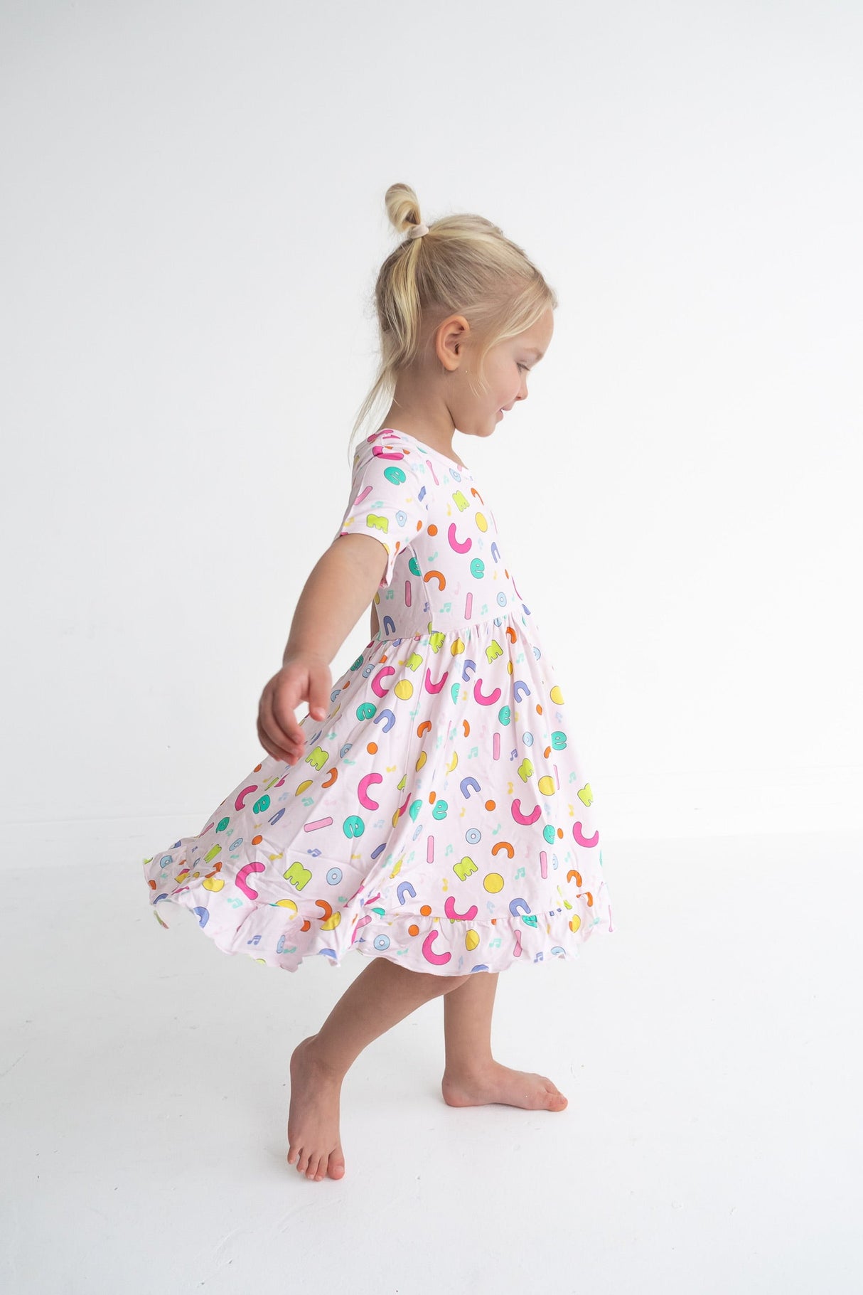 Dream Big Little Co x CoComelon ALPHABET SHORT SLEEVE DREAM RUFFLE DRESS from DREAM BIG LITTLE CO