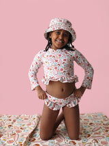 FUN IN THE SUN DREAM TWO-PIECE RASH GUARD RUFFLE SWIM SUIT from DREAM BIG LITTLE CO