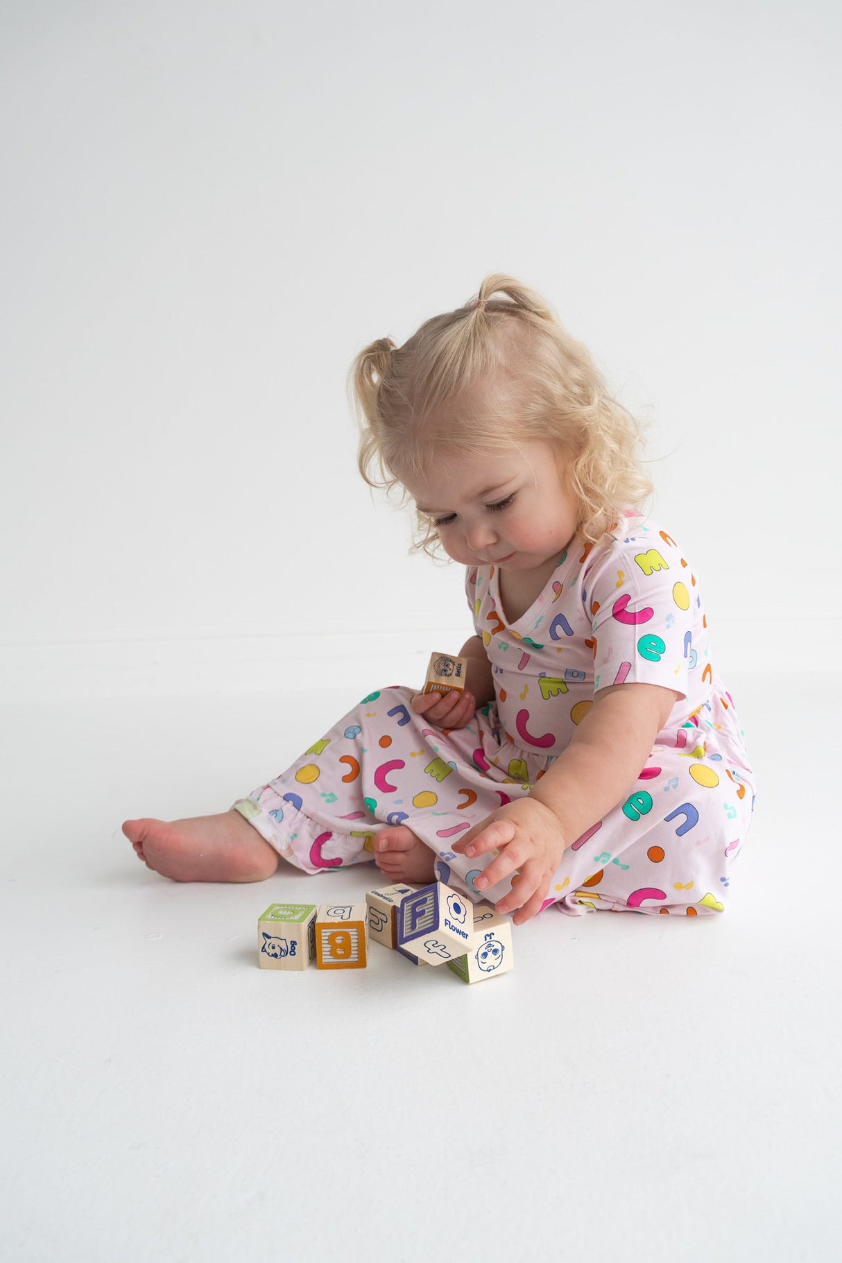 Dream Big Little Co x CoComelon ALPHABET SHORT SLEEVE DREAM RUFFLE DRESS from DREAM BIG LITTLE CO