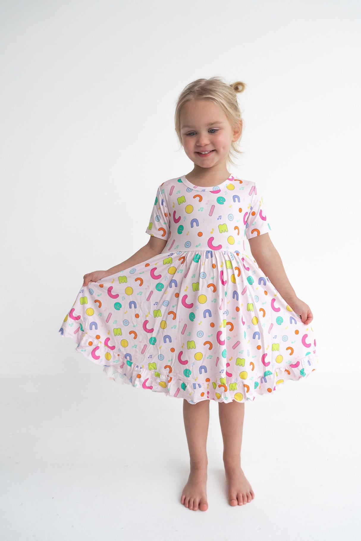 Dream Big Little Co x CoComelon ALPHABET SHORT SLEEVE DREAM RUFFLE DRESS from DREAM BIG LITTLE CO