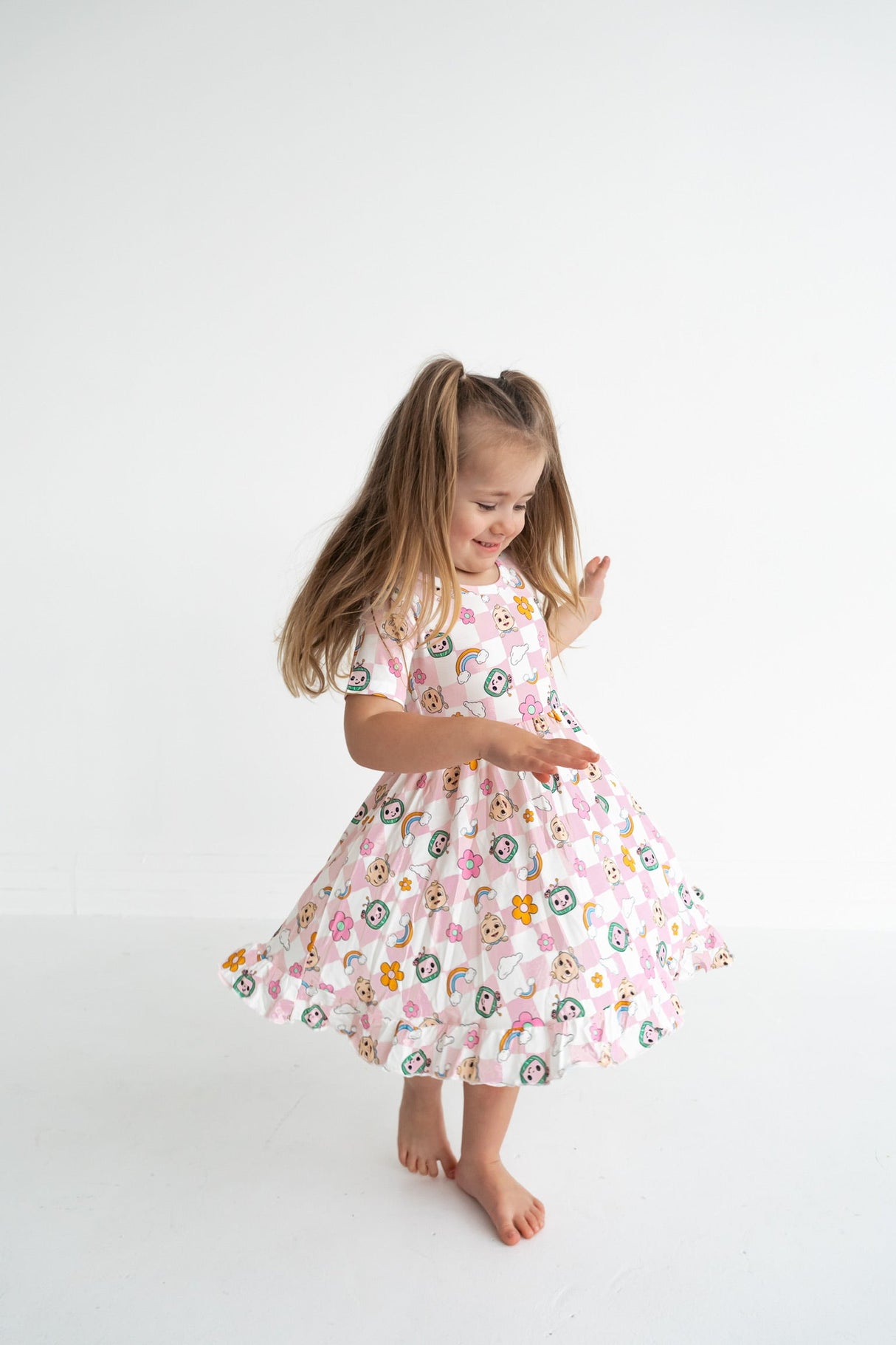 Dream Big Little Co x CoComelon JJ RAINBOW CHECKERS SHORT SLEEVE DREAM RUFFLE DRESS from DREAM BIG LITTLE CO