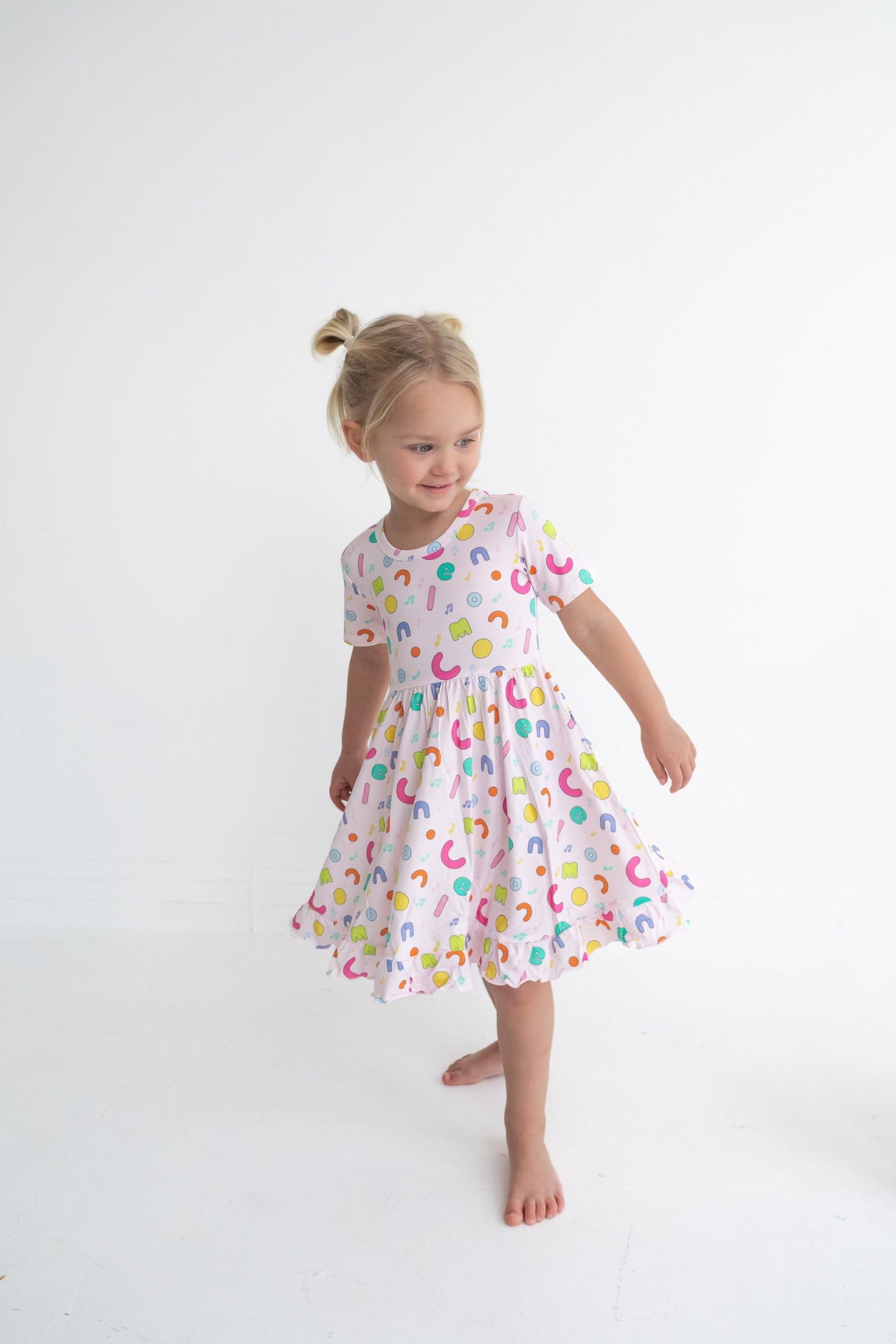 Dream Big Little Co x CoComelon ALPHABET SHORT SLEEVE DREAM RUFFLE DRESS from DREAM BIG LITTLE CO