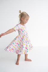 Dream Big Little Co x CoComelon ALPHABET SHORT SLEEVE DREAM RUFFLE DRESS from DREAM BIG LITTLE CO