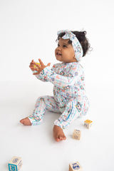 Dream Big Little Co x CoComelon SPRINGTIME MELON DREAM RUFFLE ROMPER from DREAM BIG LITTLE CO