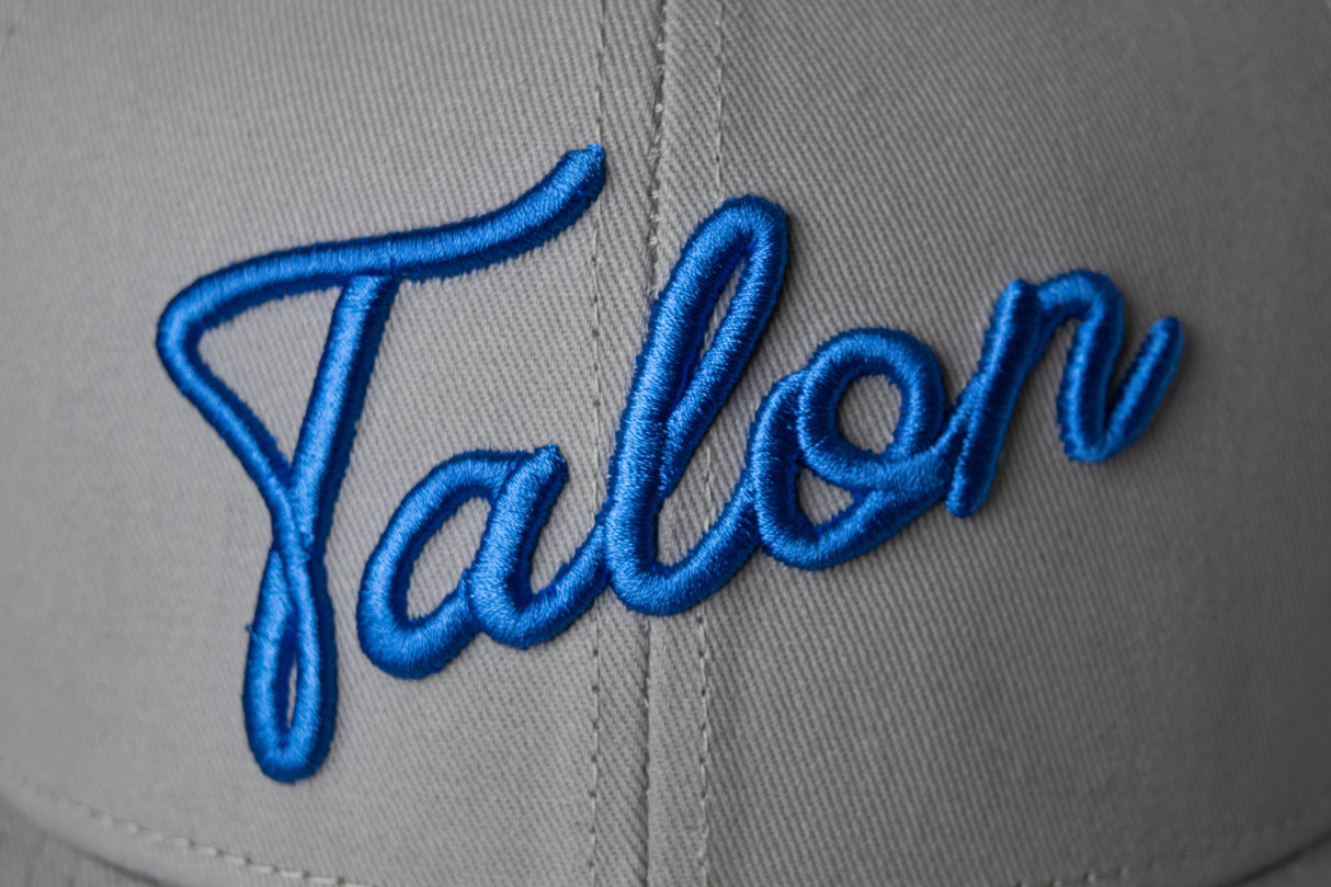 Flat Brim Hat - Grey w/ Royal Script from Talon Golf LLC