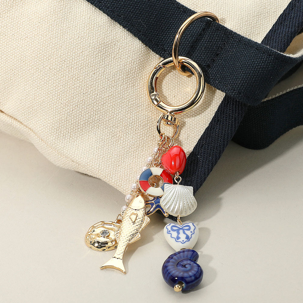 American USA Ceramic Spiral Shell Bow Heart Sea Shell Link Enamel Tube Starfish Fish Charm Drop Embellished Keychain / Bag Charm from Madeline Love