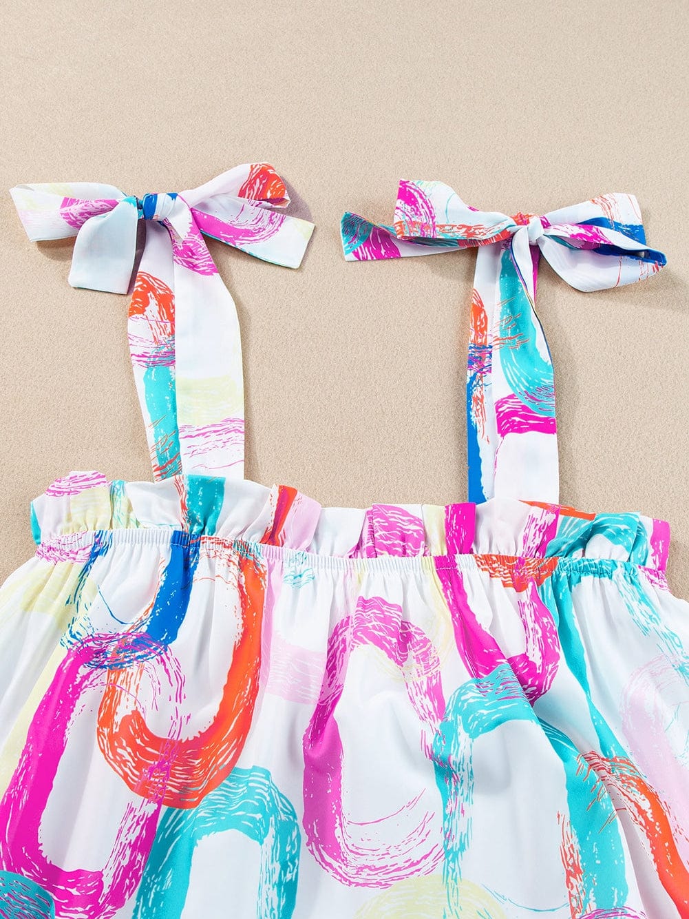Abstract White Ruffled Mini Dress with Knotted Straps from MsDressly