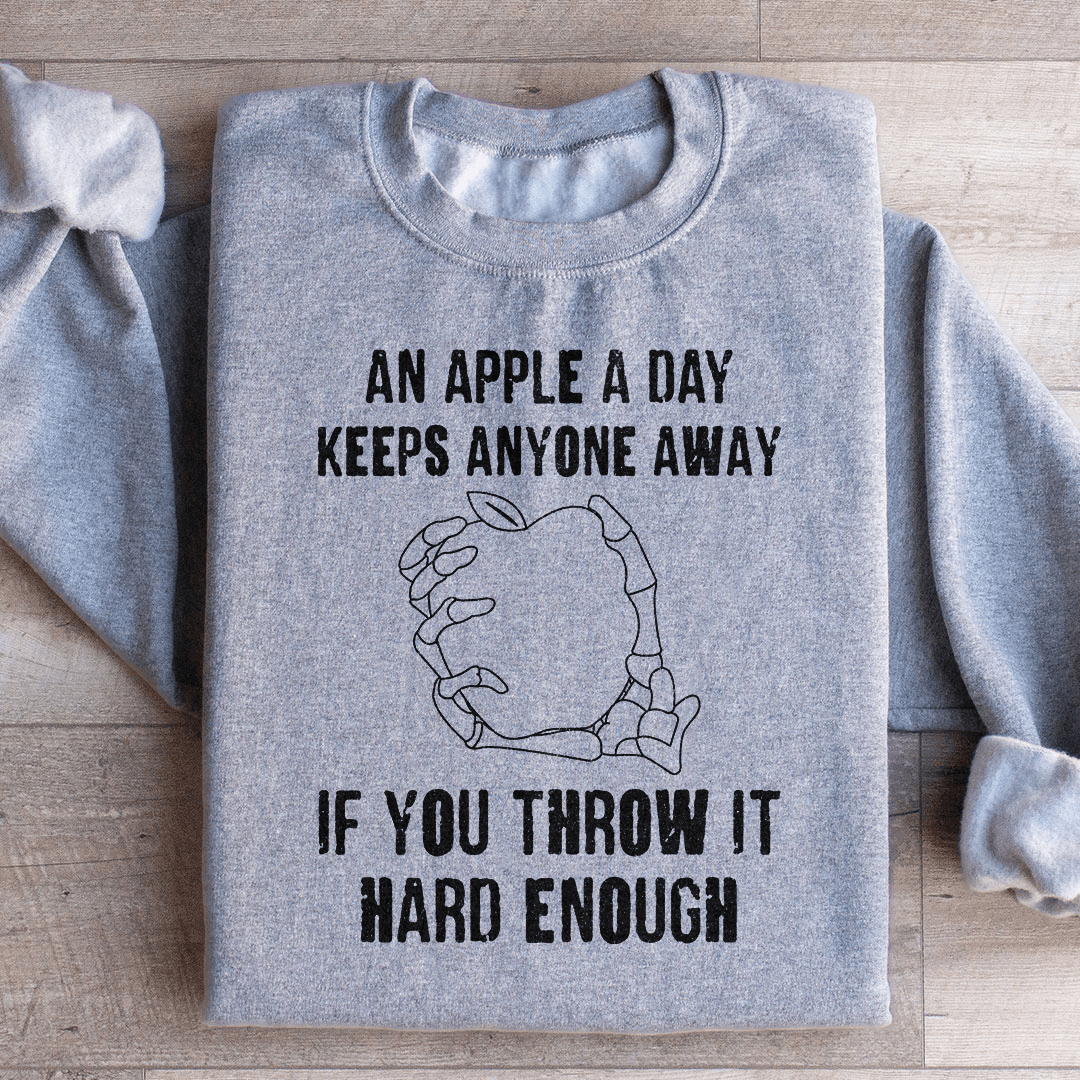 An Apple A Day Keeps Anyone Away If You Throw It Hard Enough Sweatshirt from Peachy Sunday