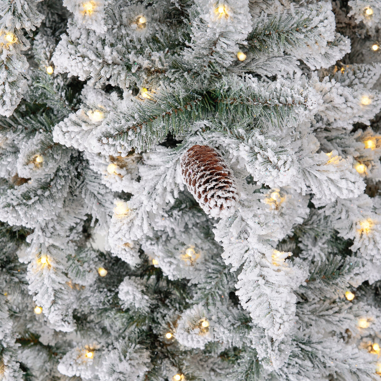 11’ Flocked Livingston Fir Artificial Christmas Tree with Pine Cones, 950 Clear Warm LED Lights and 3016 Bendable Branches from Nearly Natural