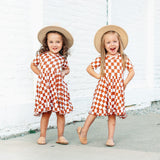 COPPER CHECKERS DREAM RUFFLE DRESS from DREAM BIG LITTLE CO