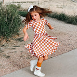 COPPER CHECKERS DREAM RUFFLE DRESS from DREAM BIG LITTLE CO