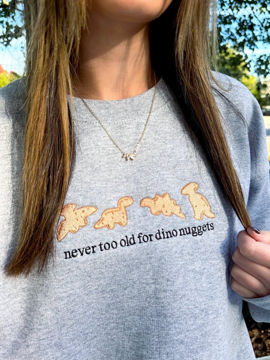 'Never Too Old For Dino Nuggets' Embroidered Crewneck Sweatshirt from United Monograms