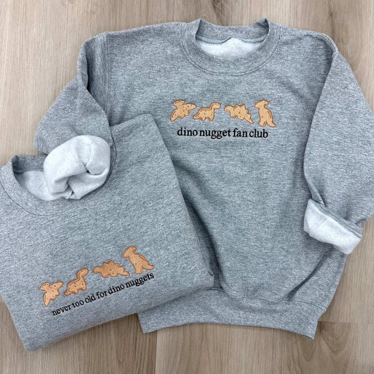 'Never Too Old For Dino Nuggets' Embroidered Crewneck Sweatshirt from United Monograms