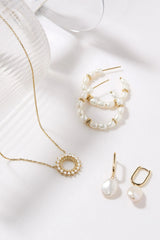 Oval Huggie Hoops With Pearl Drop Earrings from eklexic